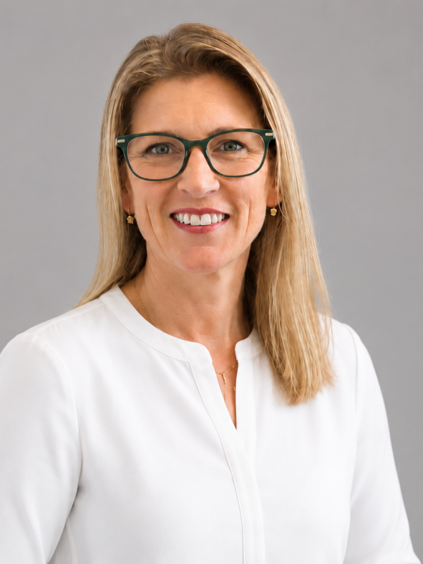 Smiling woman in white blouse.