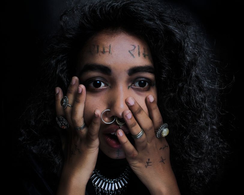 Person with tattoos and jewelry.